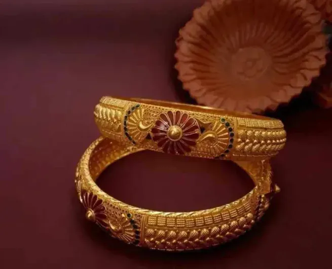 Intricately crafted gold bangles with floral details