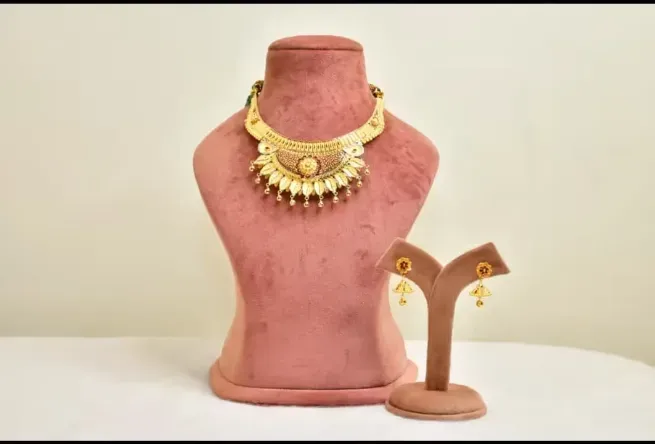 A gold jewellery set displayed in the showroom